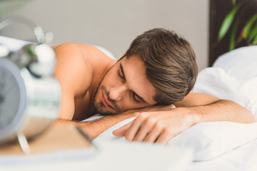 Obraz na płótnie Canvas Calm guy sleeping in bedroom