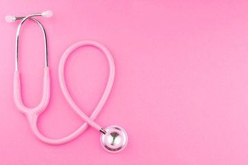 Pink stethoscope on pink background