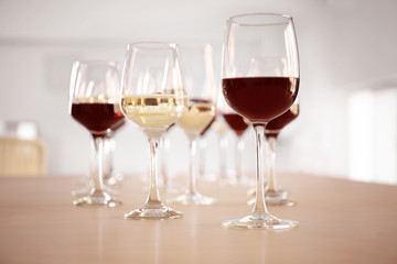 Glasses with red and white wine on table in restaurant