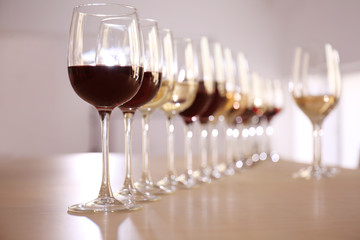 Glasses with red and white wine on table in restaurant
