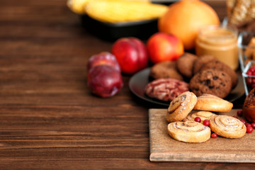 Assortment of delicious products on wooden background
