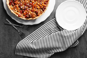 Delicious cake with nuts on table