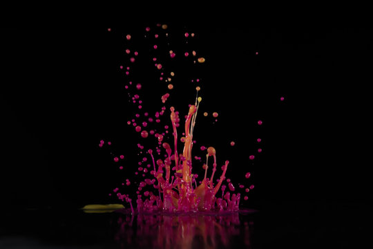 Аbstract sculptures of colorful splashes of paint. Dancing liquid on a black background. Ink water splash. Color explosion.