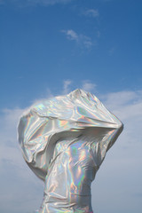 Person draped in silver fabric