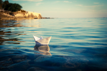 Paper Ship Floating in the Sea. Origami Paper Boat Sailing. Beautiful Waves Ripple Background....