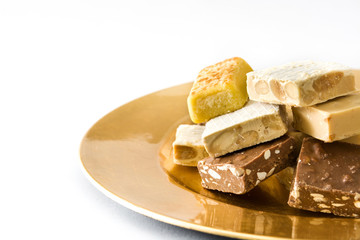 Christmas nougat on a golden plate isolated on white background
