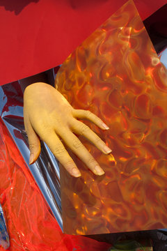 Hand with orange and red background, artwork 