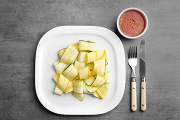 Slices of zucchini on white plate