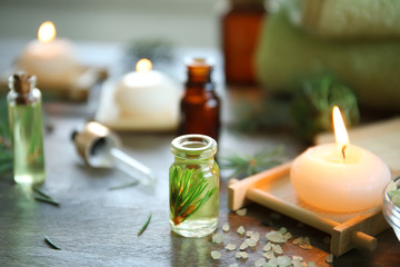 Obraz na płótnie Canvas Bottle of pine essential oil on wooden table