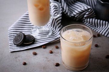 Iced coffee with milk on grey table
