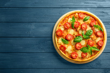 Fresh tasty pizza Margarita on wooden background