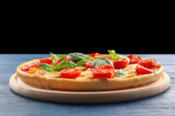 Fresh tasty pizza Margarita on black background