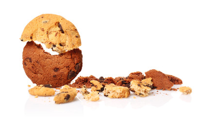 Tasty cookies with chocolate chips and crumbs on white background