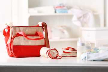 Mothers bag and accessories on table