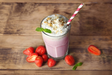 Strawberry milk shake on wooden background