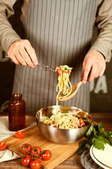 Chef cook holding pasta on a fork