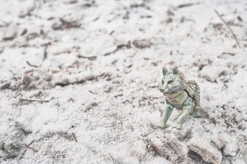 toy wolf in a snowy field