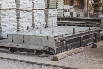 Stack of precast reinforced concrete slabs in a house-building factory workshop