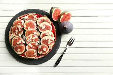 Delicious fig cake with almond flakes on plate