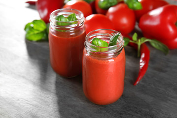 Glass jars with vegetable smoothie on wooden table