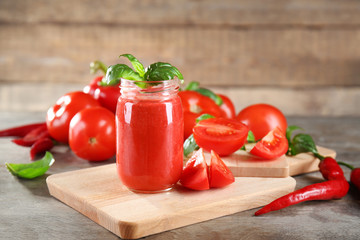 Glass jar with fresh vegetable smoothie on wooden table
