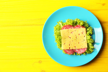 Plate with tasty food on wooden background, top view