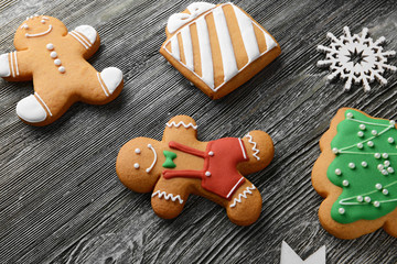 Tasty cookies and Christmas decor on wooden table, close up view