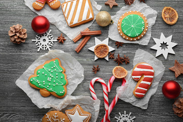 Composition of cookies and Christmas decor on wooden table