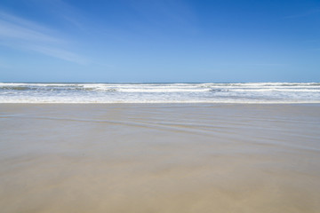 Fototapeta na wymiar Waves and blue sky at Torres beach