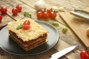 Homemade meat lasagna on wooden table