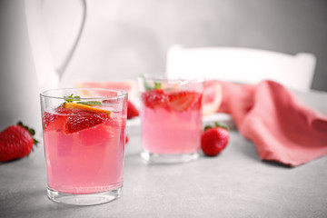 Glass of refreshing drink on table