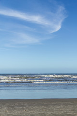 Fototapeta na wymiar Waves and blue sky at Torres beach