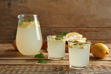 Glasses of refreshing lemonade on table