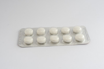 white pills tablets in a blister drugs