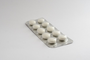 white pills tablets in a blister drugs