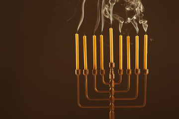 Menorah with blown out candles for Hanukkah on black background © Africa Studio