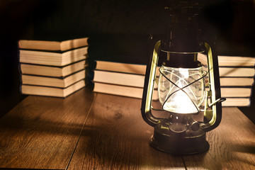 The light of kerosene lamp and books on the table