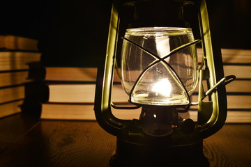 The light of kerosene lamp and books on the table
