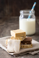 Christmas nougat and milk on wooden background
