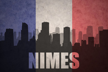 abstract silhouette of the city with text Nimes at the vintage french flag