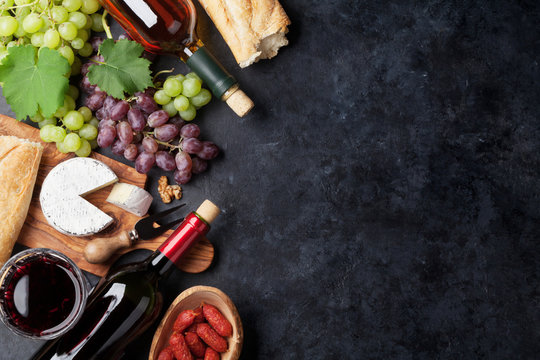 Red and white wine, grape, cheese and sausages