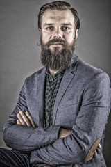 Portrait of an elegant young fashion man with beard and mustache
