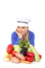 Beautiful young chef next to her fresh vegetables