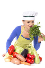 Beautiful young chef  holding fresh parsley