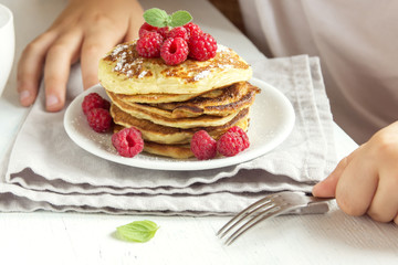 Child eating pancakes