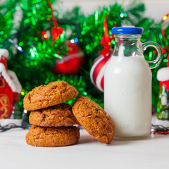 Cookies and milk on christmas background.