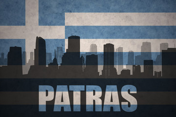 abstract silhouette of the city with text Patras at the vintage greece flag
