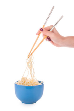 Hand holding chopsticks, eating noodles isolated on white background