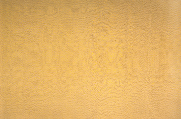 background in the form of a fabric material and the gold and bronze colors of textiles