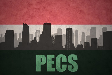 abstract silhouette of the city with text Pecs at the vintage hungarian flag